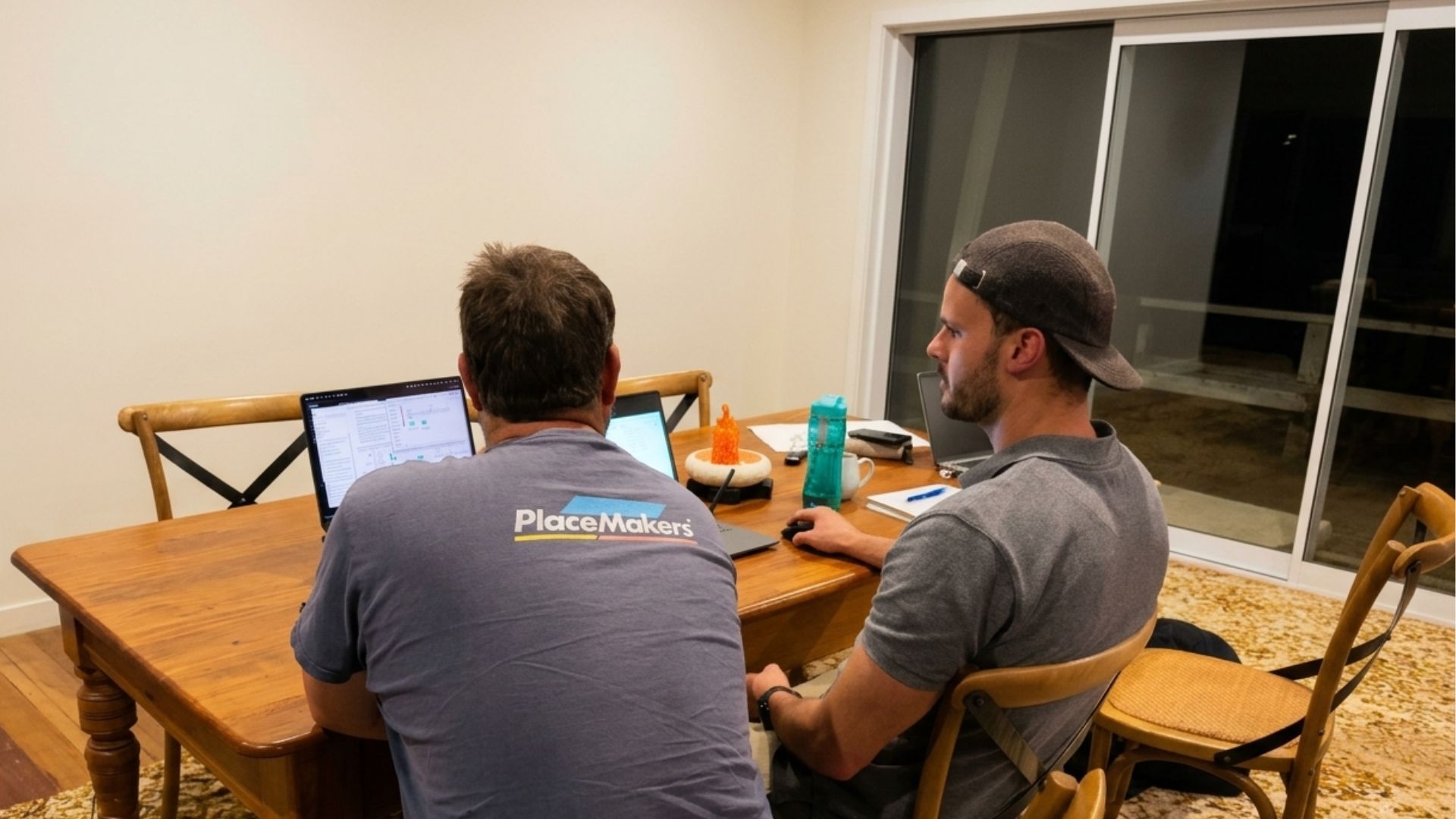 Matt from Business Performance Systems and a trade business owner, working side by side at a table with laptops open during the systems build